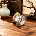 925 sterling silver Pixiu wealth ring gold and silver versions with Taoist rune band on wooden table