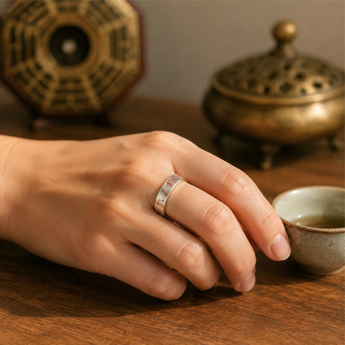 Man wearing S925 silver BeiDou seven star talisman ring, Taoist incense burner and Bagua background