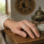 Woman wearing S925 silver BeiDou talisman fortune ring on finger, Taoist Bagua background