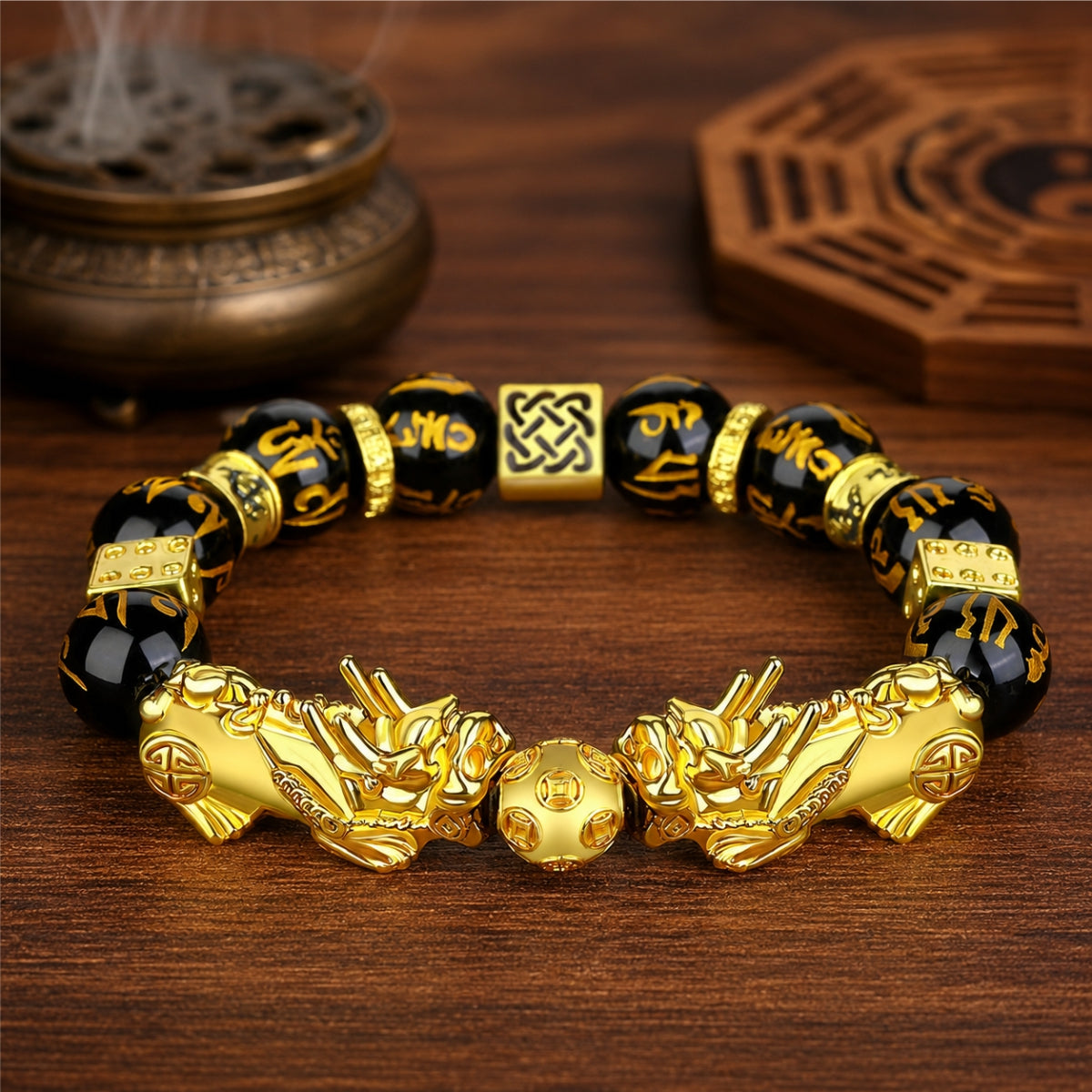 Double gold Pixiu wealth bracelet with black obsidian six-syllable mantra beads, infinity knot spacers, and fortune bead.