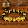 Double Pixiu wealth attraction and retention bracelet with black obsidian mantra beads and a central fortune bead.