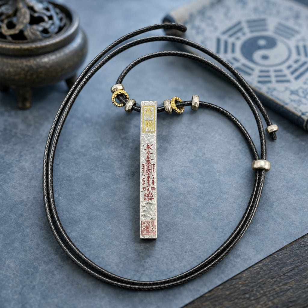 Full view of a Taoist supreme protection and fortune talisman necklace with silver pendant, cinnabar inscriptions, and adjustable black cord.