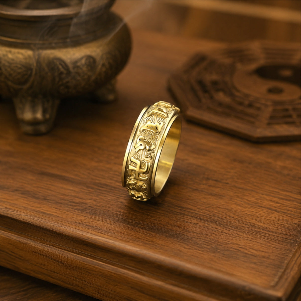 Gold-tone Taoist protection spinner ring with engraved rune details and a rotating band.