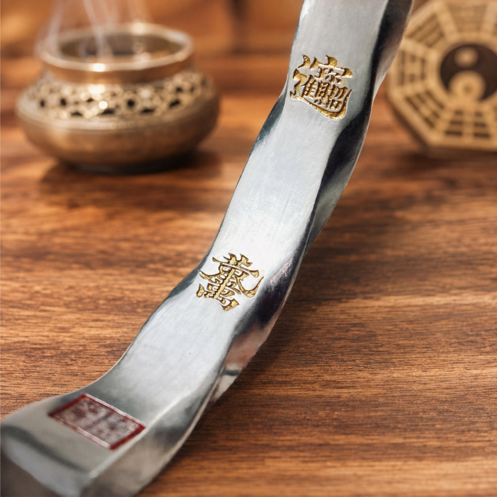 Inner view of a Taoist Mobius protection bracelet with gold-tone fortune talisman details and cinnabar seal.