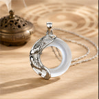 Natural white jade koi love necklace with sterling silver koi detailing and a Taoist-inspired pendant design.
