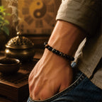 Man wearing a workplace energy protection bracelet with black and tiger eye beads