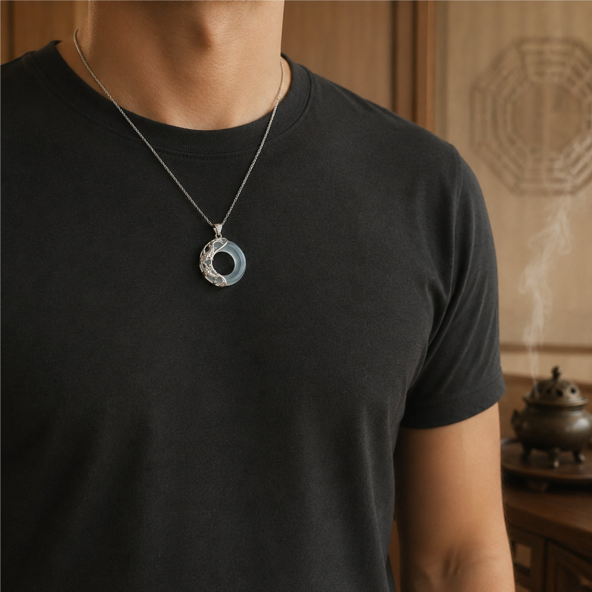 Male wearer with a dark jade koi love necklace featuring a sterling silver koi pendant design.