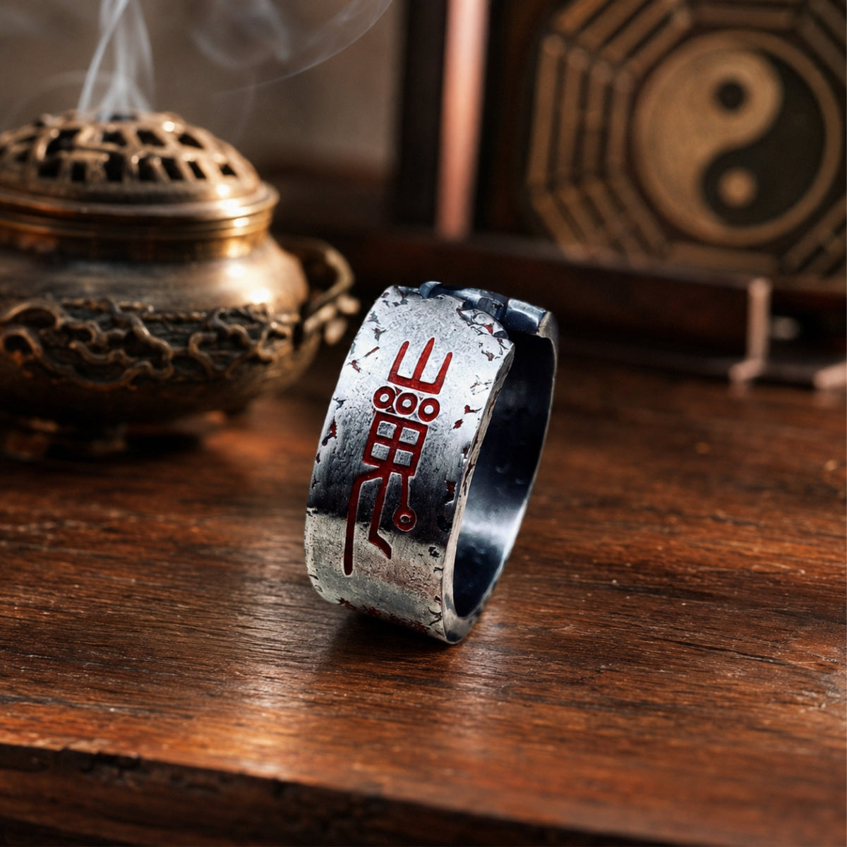 Close-up of a Taoist Mountain Ghost protection ring showing a red cinnabar Shan Gui talisman on antiqued silver.