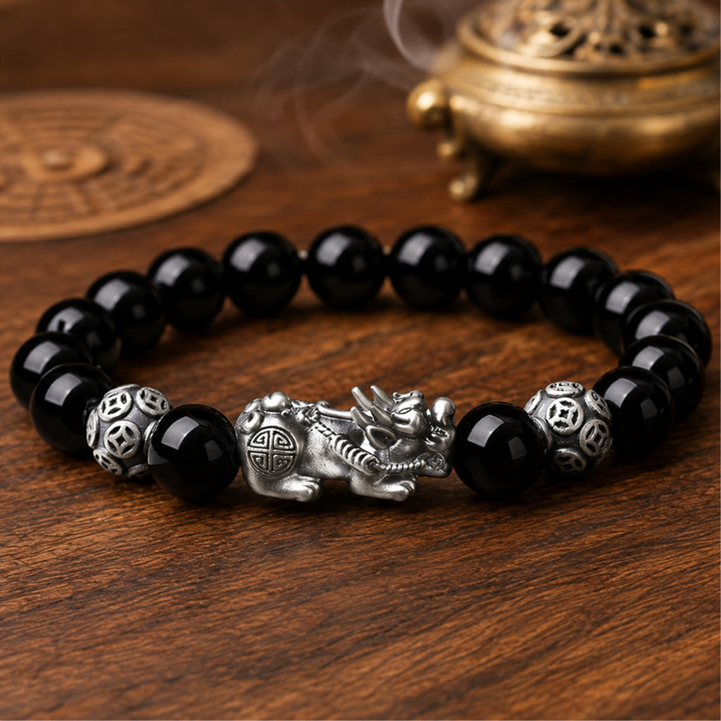 Natural black obsidian Pixiu wealth and protection bracelet with a silver Pixiu centerpiece and guardian beads.