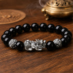 Natural black obsidian Pixiu wealth and protection bracelet with a silver Pixiu centerpiece and guardian beads.