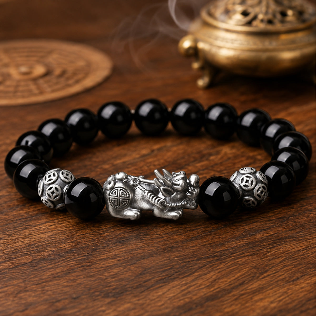 Natural black obsidian Pixiu wealth and protection bracelet with a silver Pixiu centerpiece and guardian beads.