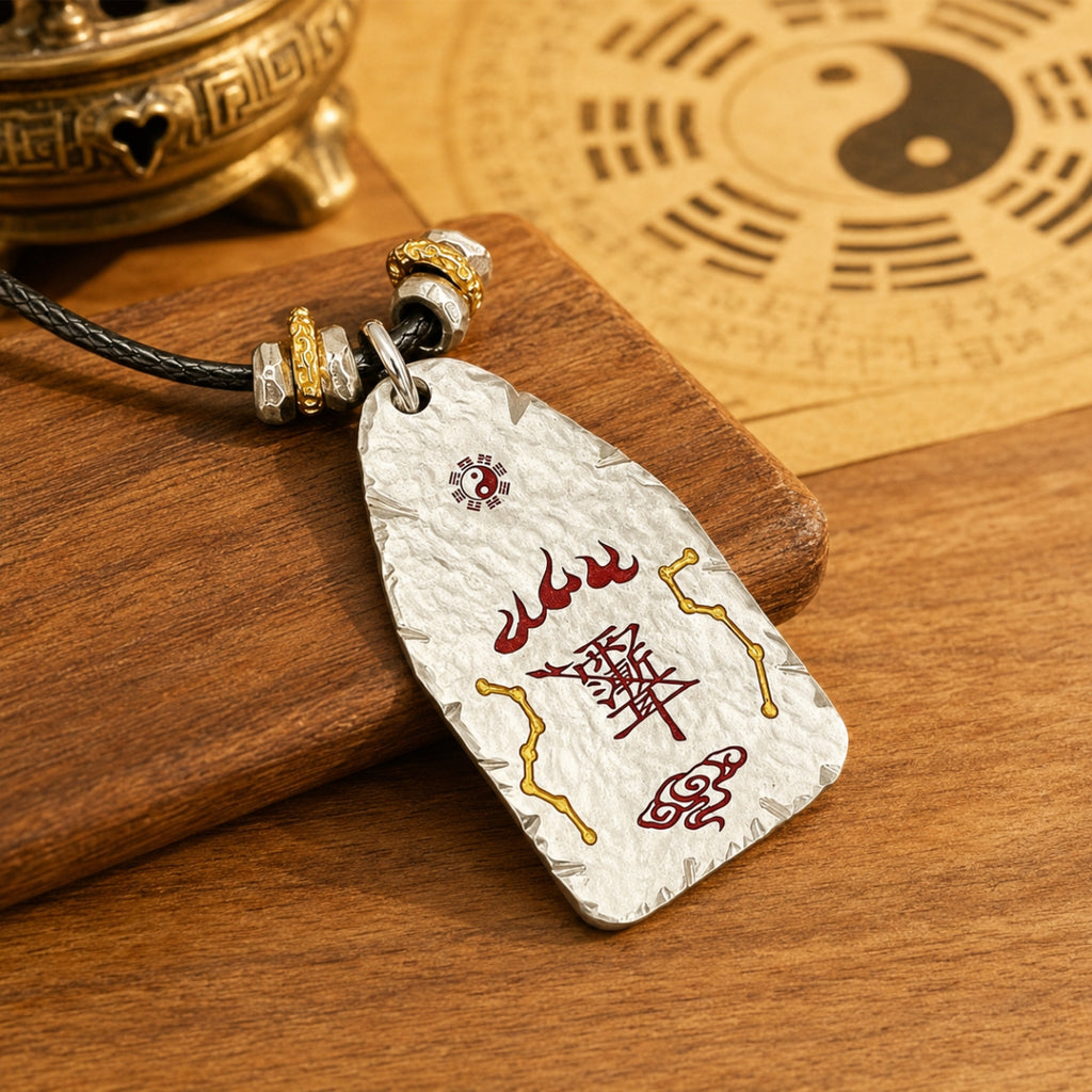 Reverse side of a hand-hammered Taoist protection talisman showing cinnabar evil-warding symbols and a Yin-Yang detail