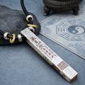 Close-up of a 925 silver Taoist talisman pendant showing cinnabar sacred inscriptions, Celestial Master Seal, and black cord.