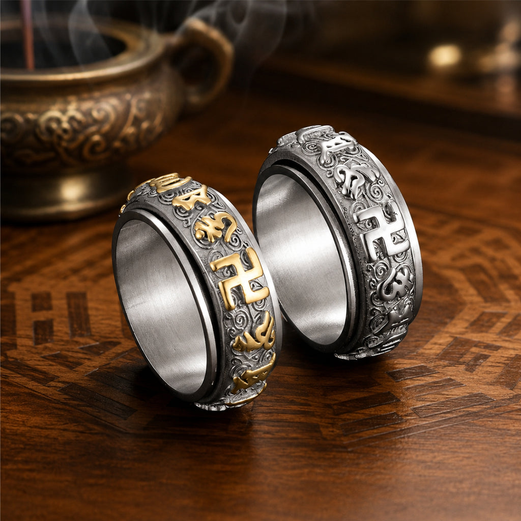 Two engraved Taoist protection spinner rings with rotating outer bands, shown in silver and gold-tone designs.