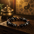 Taoist Kaiguang negative energy protection bracelet displayed with incense and a yin yang Bagua symbol