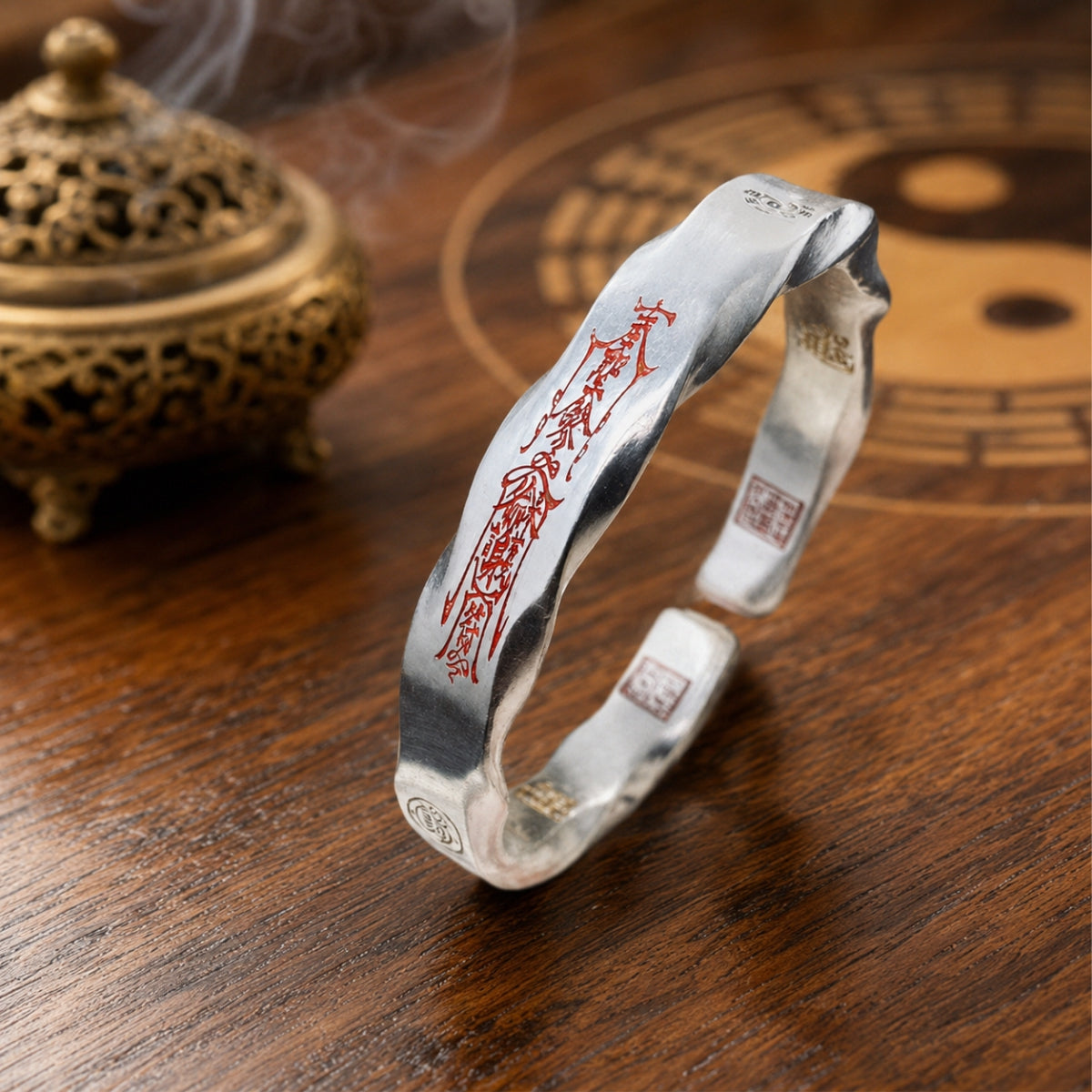 Taoist Mobius protection bracelet with red cinnabar outer protection talisman and engraved inner fortune symbols.