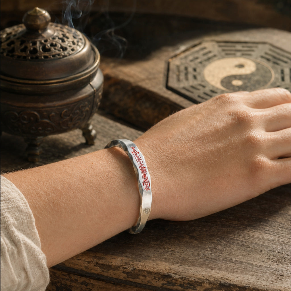 Taoist Mobius protection bracelet worn on the wrist, showing the outer red cinnabar protection talisman.