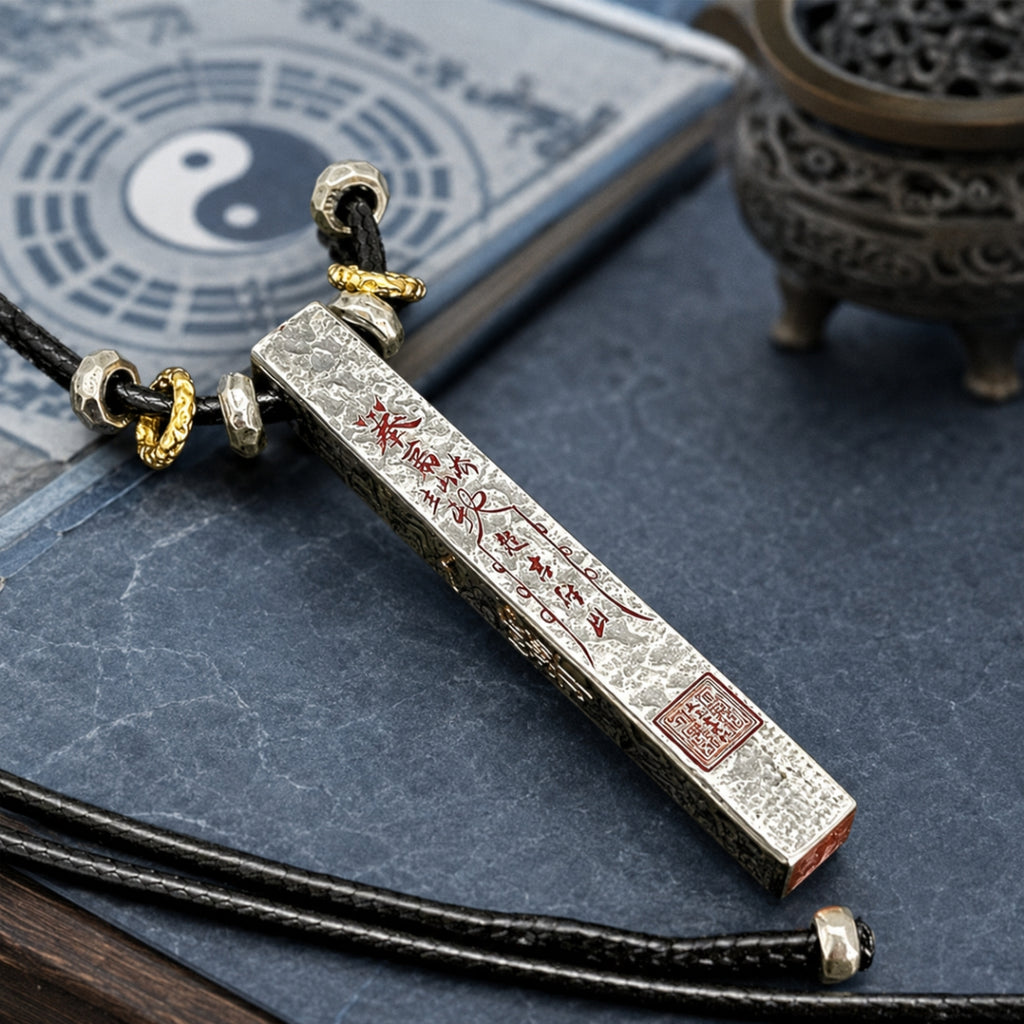 925 silver Taoist supreme talisman necklace with hand-finished cinnabar details, displayed with Bagua and incense burner.