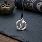 Handcrafted sterling silver Taoist Qiankun circle pendant with engraved Yin Yang symbols and black cord.