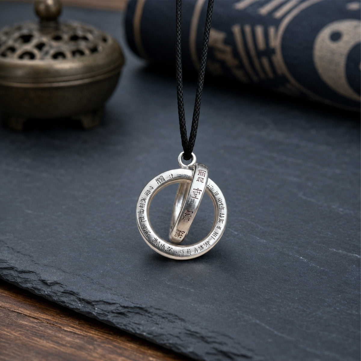 Handcrafted sterling silver Taoist Qiankun circle pendant with engraved Yin Yang symbols and black cord.