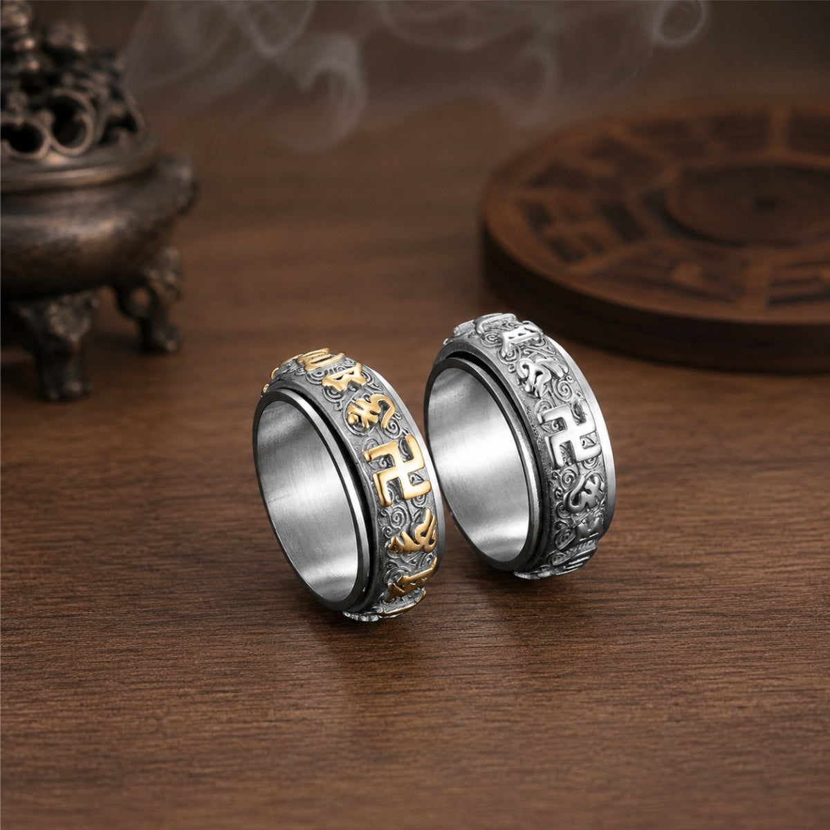 Silver and gold-tone Taoist protection spinner ring variants with engraved talisman-style symbols.