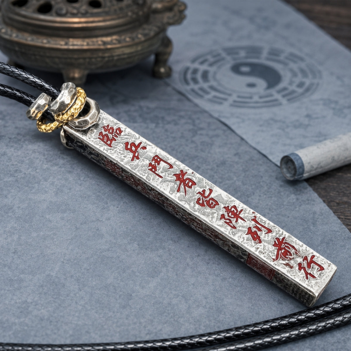 Hand-finished silver Taoist supreme protection and fortune talisman pendant with red cinnabar inscriptions and black cord.