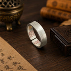 Side view of a handcrafted sterling silver Taoist protection ring showing its concealed cinnabar talisman engravings