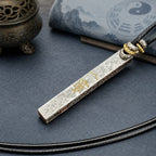 Reverse side of a 925 silver Taoist supreme talisman pendant with gold Thunder Talisman detail and black cord.