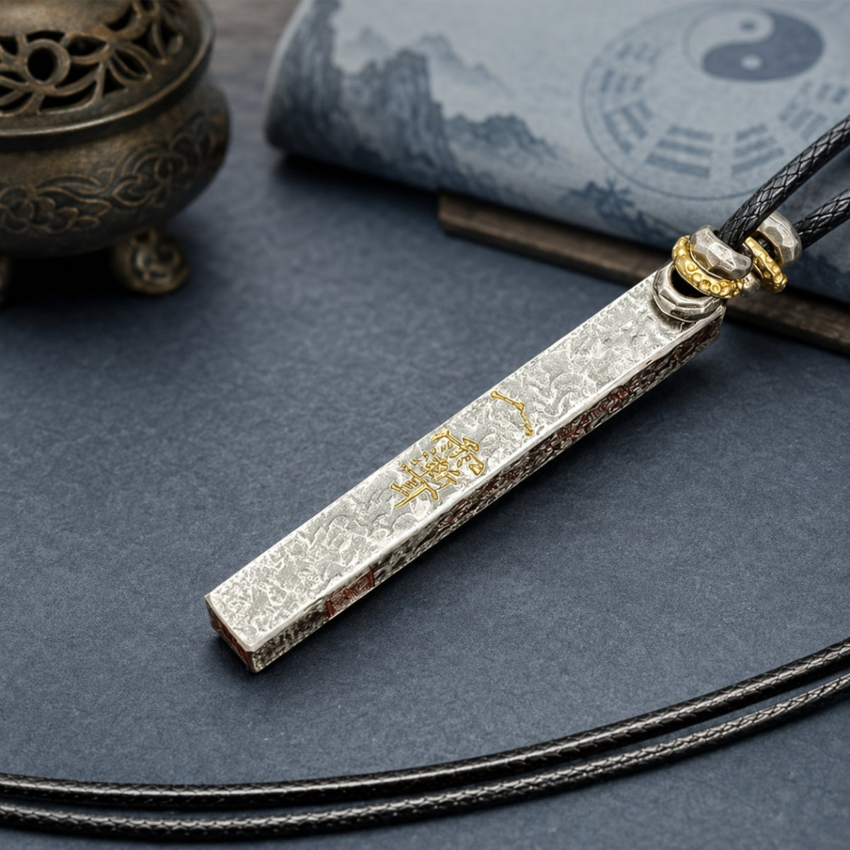 Reverse side of a 925 silver Taoist supreme talisman pendant with gold Thunder Talisman detail and black cord.
