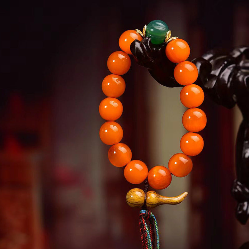 Taoist wealth attraction bracelet with orange South Red Agate beads and a hand-carved wealth-gathering gourd pendant