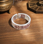 Full view of a Taoist wealth attraction ring with red cinnabar wealth talisman engraving and inner Celestial Master Seal.