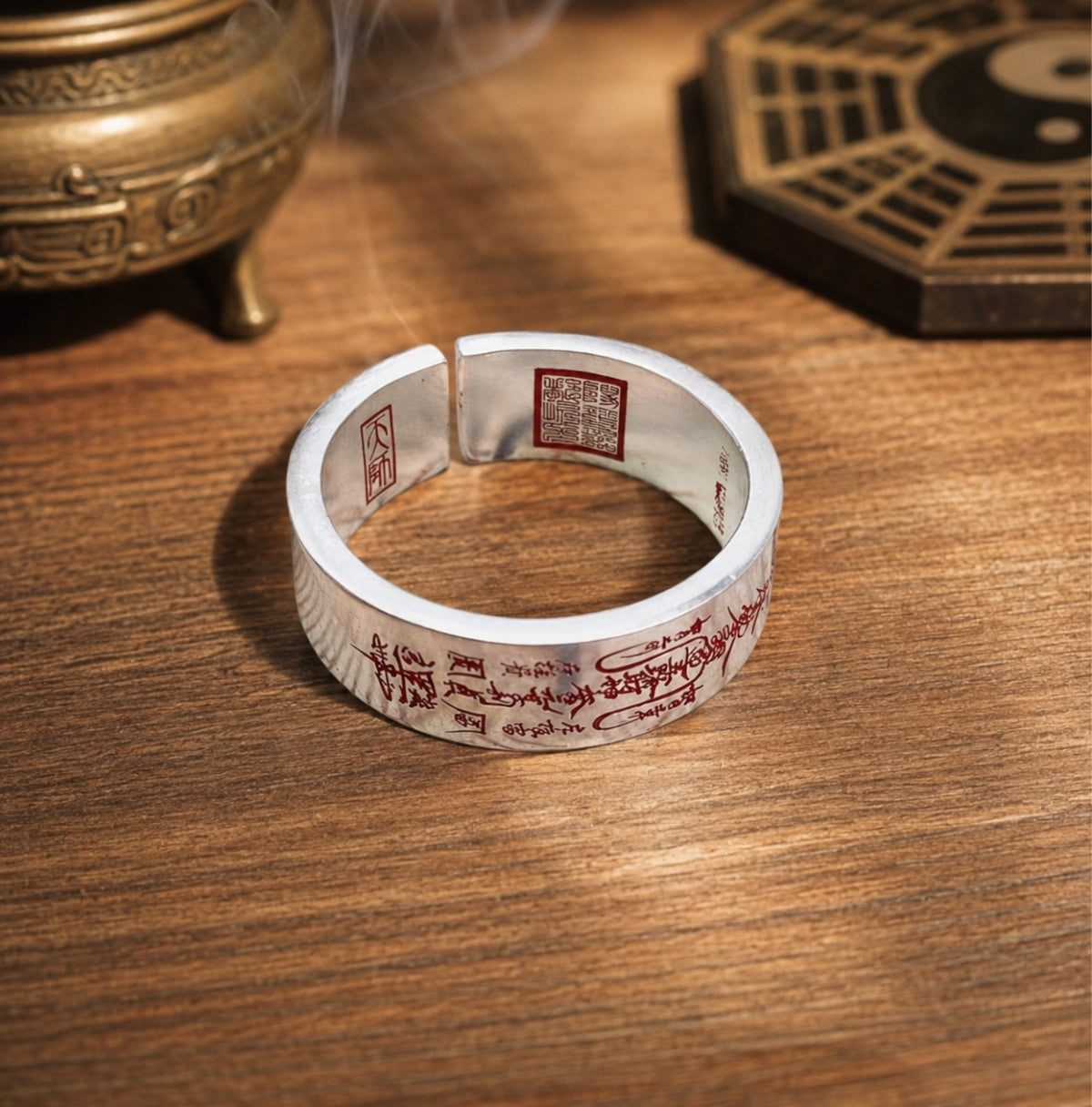 Full view of a Taoist wealth attraction ring with red cinnabar wealth talisman engraving and inner Celestial Master Seal.