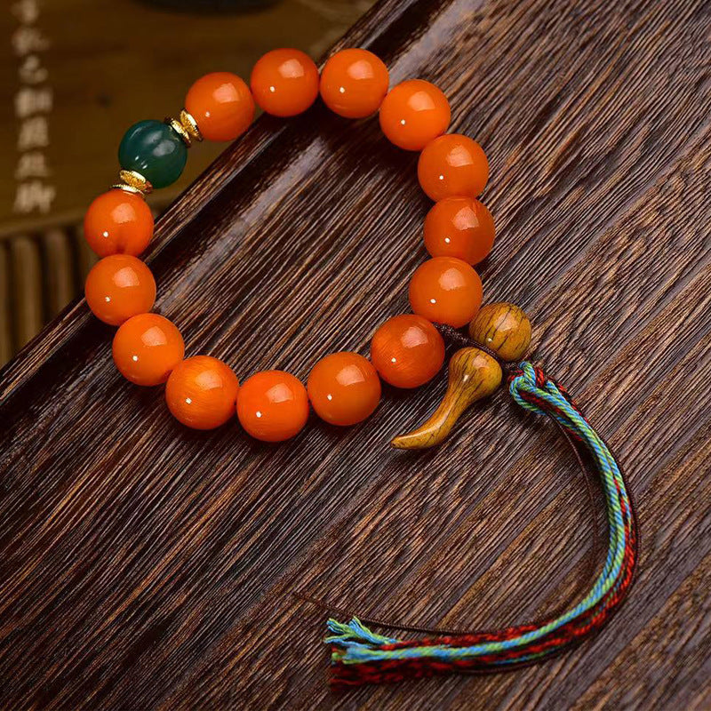 South Red Agate wealth attraction bracelet for women with a green jade accent bead, Taoist gourd pendant, and five-element tassel