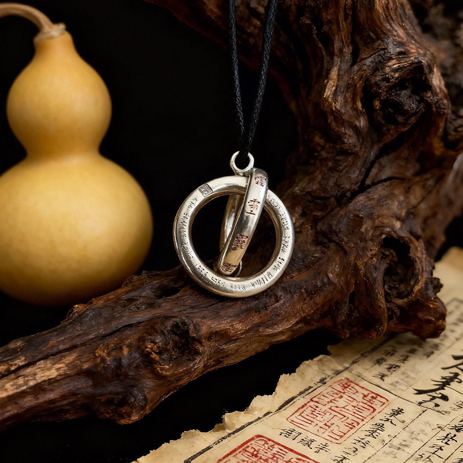 Handcrafted Taoist Yin Yang balance pendant displayed with a traditional gourd and Daoist talisman paper.