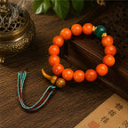 South Red Agate wealth attraction bracelet for women with a Taoist wealth-gathering gourd, displayed beside incense