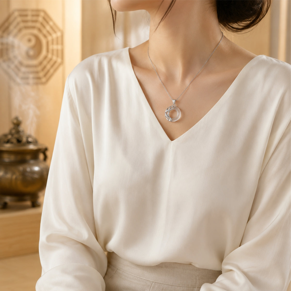 Female wearer with a natural white jade koi love necklace featuring sterling silver koi details.