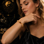 Elegant blonde woman wearing citrine tiger eye abundance manifestation bracelet black silk dress gold Taoist yin yang background Longhu Mountain KaiGuang courage prosperity