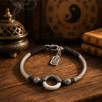 Jade peace buckle protection bracelet silver twisted rope black braided cord yin yang beads carved silver spacers ping an charm pendant on dark wooden table bronze incense burner smoke yin yang bagua backdrop Taoist KaiGuang evil warding amulet