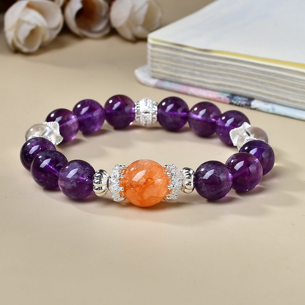 Amethyst crown chakra bracelet strawberry quartz clear quartz silver spacers overhead view cream white background book spiritual awakening KaiGuang