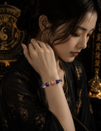 Asian woman wearing amethyst crown chakra bracelet strawberry quartz clear quartz silver spacers black silk dress Taoist yin yang gold background KaiGuang