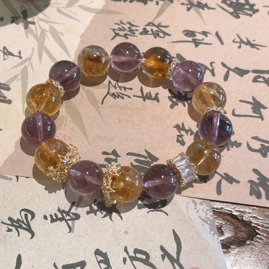Natural ametrine crystal anxiety relief bracelet with purple amethyst and golden citrine beads gold crown spacers displayed on traditional Chinese calligraphy paper Taoist KaiGuang