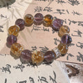 Natural ametrine crystal anxiety relief bracelet with purple amethyst and golden citrine beads gold crown spacers displayed on traditional Chinese calligraphy paper Taoist KaiGuang