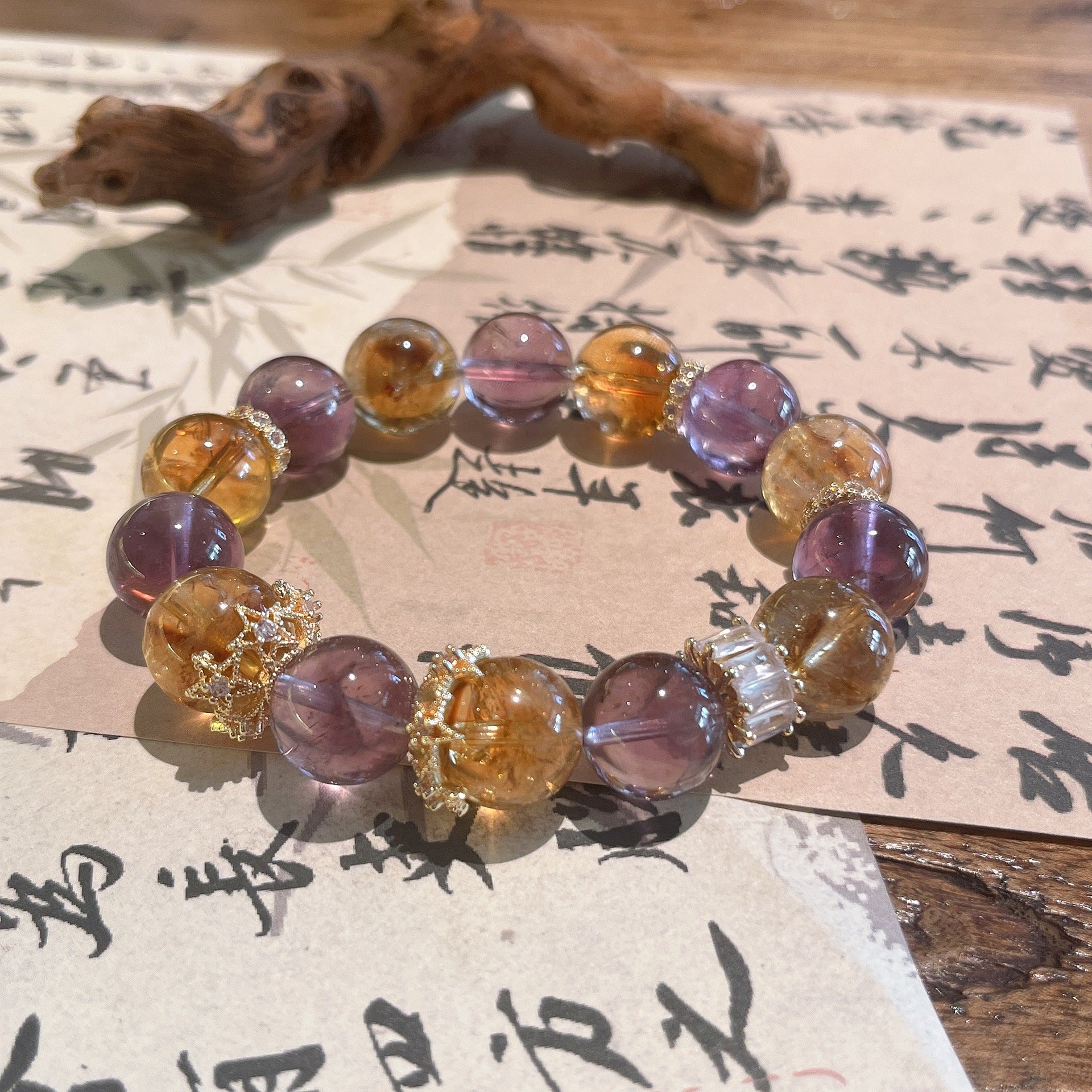 Ametrine crystal anxiety relief bracelet with amethyst citrine beads and gold spacers on traditional Chinese calligraphy paper with wooden carving Taoist KaiGuang deep sleep calm