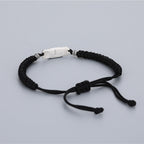 Black string Taoist luck bracelet with engraved S925 silver talisman charm, white background