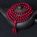 108-bead purple cinnabar meditation mala draped on a dark teapot, supreme yang anchor.