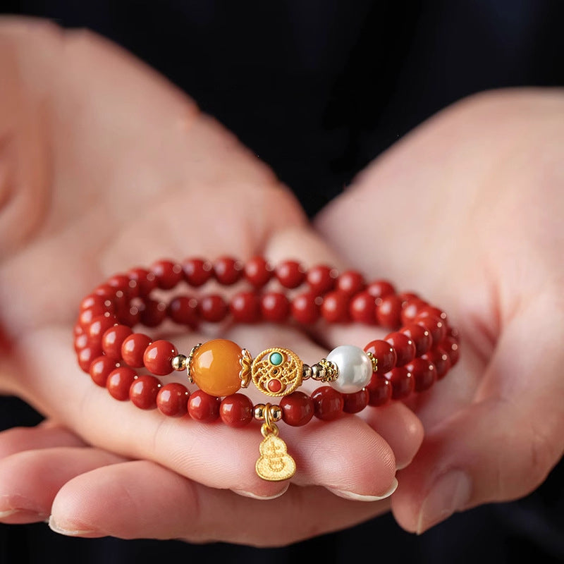 Woman cradling a red cinnabar bracelet in both hands — Taoist KaiGuang consecrated protection jewelry