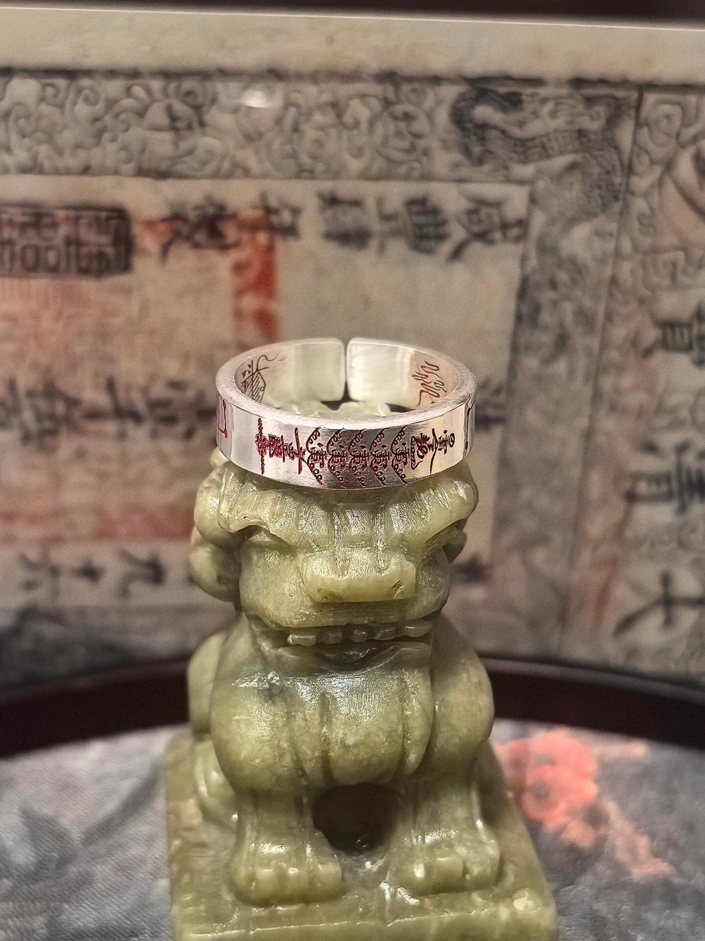 Close-up on the cinnabar-infused lightning seals, symbolizing the purest Yang force resting on the guardian lion for mental clarity.