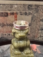 Close-up on the cinnabar-infused lightning seals, symbolizing the purest Yang force resting on the guardian lion for mental clarity.