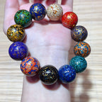 Colorful handmade lacquer bracelet 15mm beads held in palm showing unique multicolor lacquer patterns Taoist KaiGuang wealth protection artisan spiritual jewelry