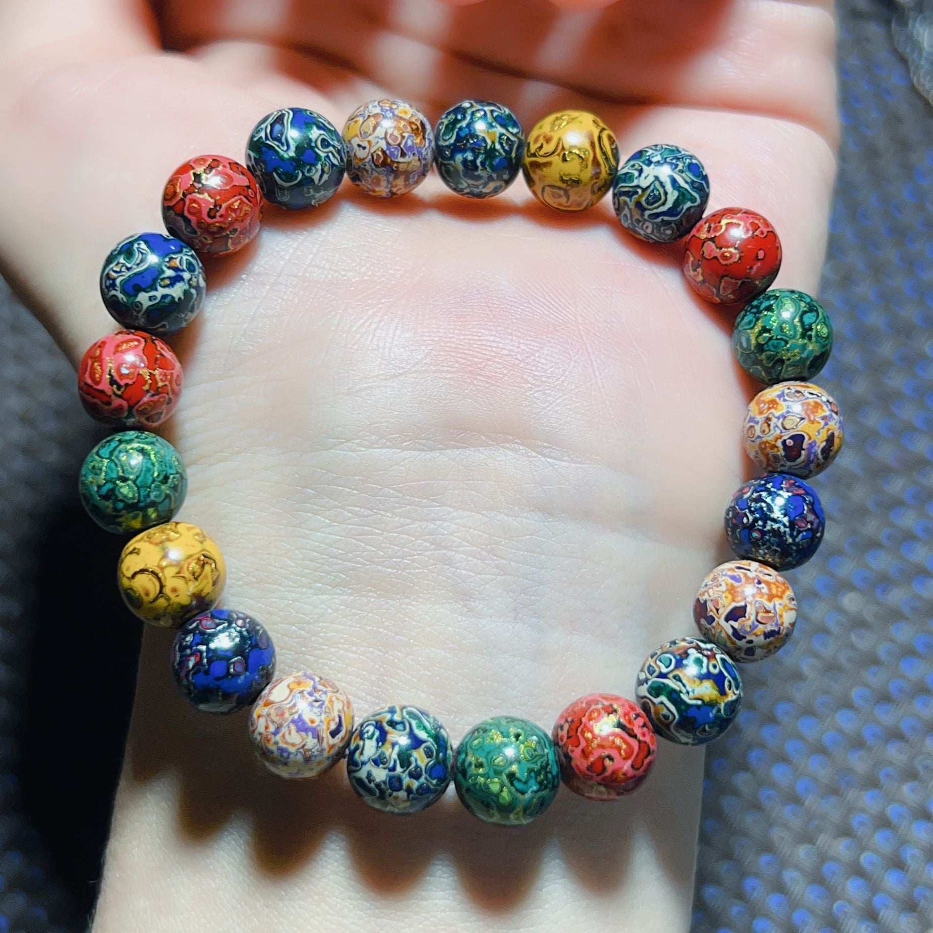 Colorful handmade lacquer bracelet 8mm small beads worn on wrist showing full circle multicolor patterns Taoist KaiGuang wealth attraction protection women spiritual bracelet